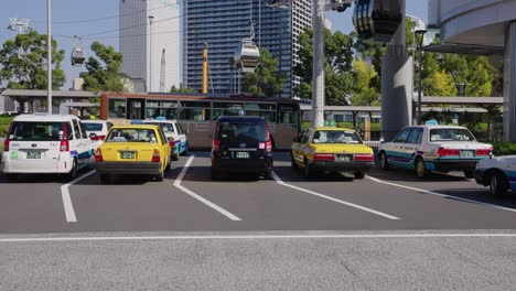 Slow-Motion-Pan-Over-Taxi's-and-Bus-Stand-at-Yokohama-Station,-Japan