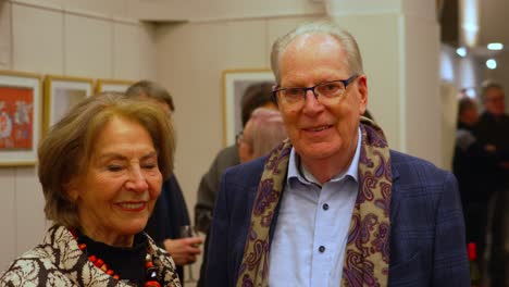 Friendly-older-male-and-female-couple-feeling-caught-and-looking-friendly-into-camera