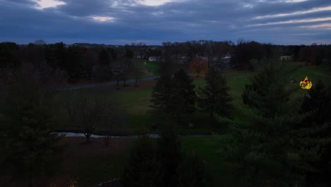 Ascending-wide-shot-of-Greenfield-Sign-and-Christmas-decoration-and-City-of-Lancaster-in-background-in-the-evening---drone-flight