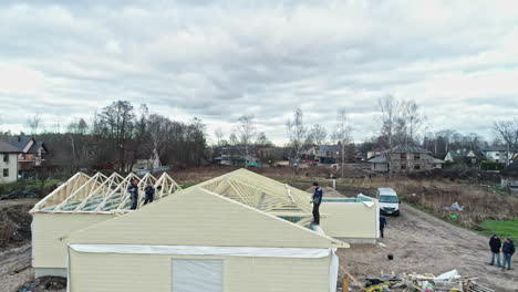 Aerial-of-workers-on-top-of-house-under-construction-new-development-project-estate