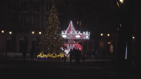 A-Family-Walk-with-Kids-Together-at-Old-town-Carousel-in-Warsaw-Poland-at-Night