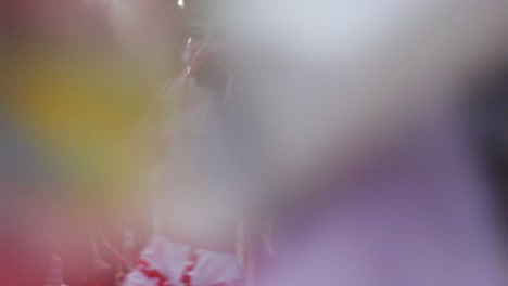 group-of-mexican-carnival-dancers-performing-traditional-huehue-dance-with-confetti-flying-at-night