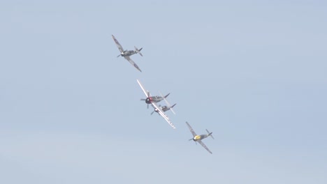 P-fifty-one-Mustang,-Spitfire,-Japanese-Zero,-and-Messerschmitt-Bf-Banking-While-Flying-in-Unison