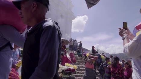 Old-colonial-church-in-Chichi,-Guatemala-during-daytime,-people-walking-in-slow-motion