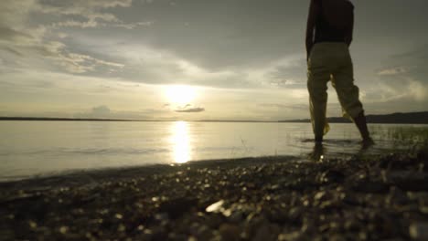 Girl-getting-inside-a-lake-at-sunset