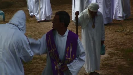 A-Catholic-Priest-is-walking-with-some-people-wearing-white-clothes