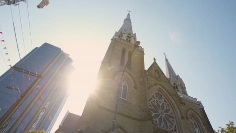 A-Slow-Motion-Low-Angle-Drive-by-Shot-of-Holy-Rosary-Cathedral-in-Vancouver,-BC