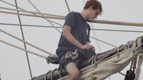 Ferdinand-Magellan-Nao-Victoria-carrack-boat-replica-mast-with-worker-fixing-ropes-in-slow-motion-60fps