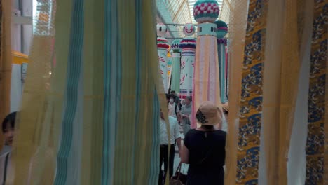 People-on-busy-street-walking-through-decorative-paper-streamers-during-Tanabata-festival-in-slow-motion