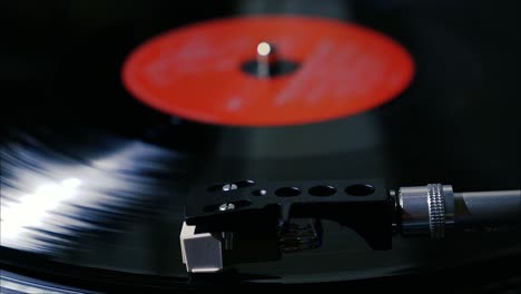 Panning-shot-of-black-vintage-vinyl-record-spinning-on-a-turntable-slow-motion