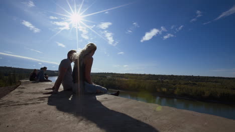 A-Wide-Dolly-Shot-of-a-Couple-Sitting-and-Talking-on-Cliffs-Edge-at-"End-of-The-World"-in-Edmonton,-Alberta