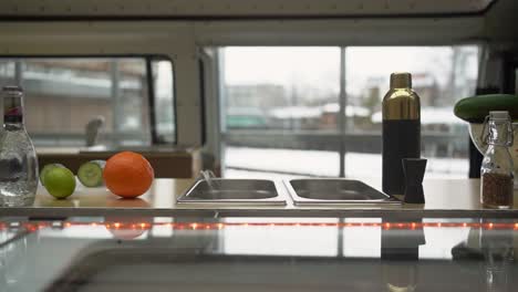 slow-motion-horizontal-slide-along-a-bar-with-bottles-standing-on-the-bar-counter