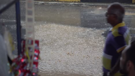 People-Passing-on-Flooded-Street-and-Sidewalk-in-Manaus,-Brazil