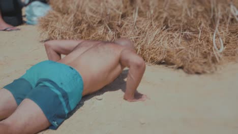 two-athletes-at-the-beach-doing-a-high-jump-on-rice-straw---Slow-Motion