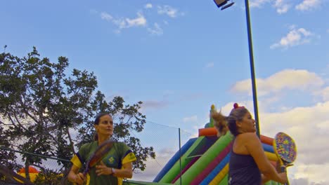 low-camera-angle-show-a-girls-team-playing-beach-tennis-in-Brazil