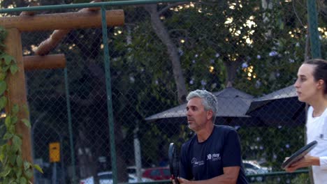 Father-and-daughter-concentrated-playing-beach-tennis-in-slow-motion