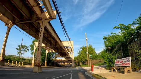 hyper-lapse-point-of-view-of-a-bike-ride-along-a-green-bike-path-in-the-city-metro-area-during-a-sunny-day