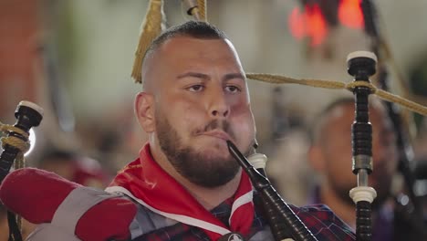 CU:-Man-plays-bagpipes-in-Easter-parade-marching-band,-Nazareth-Israel