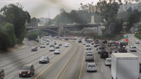 Looking-through-an-overpass-fence-towards-a-busy-highway-on-an-overcast-day