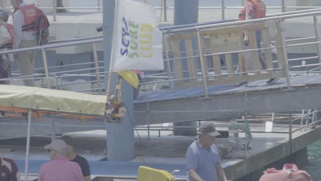 3-tourists-are-descending-to-the-embark-area-of-the-peer-in-the-Galapagos-islands