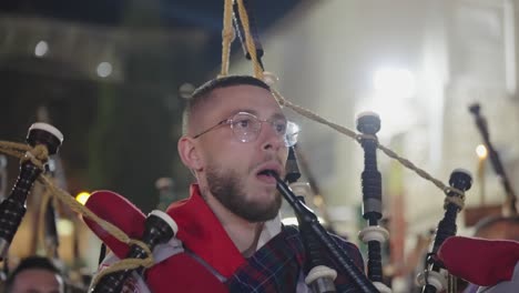 Marching-band-piper-plays-bagpipes-in-Nazareth,-Israel-Easter-parade