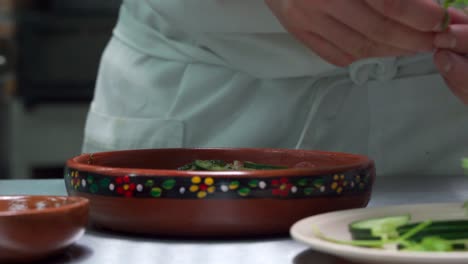 Latin-mexican-peru-chef-dressing-ceviche-on-top-with-coriander-seafood-front-view