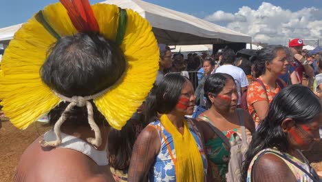 Traditionally-and-colorfully-painted-indigenous-amazon-men-and-woman-with-feather-hats-at-a-meeting