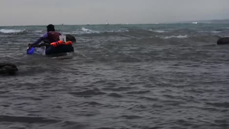 Fishermen-using-small-rubber-boats-on-the-coast-of-Rancabuaya,-Garut,-West-Java,-Indonesia