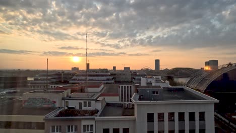 Looking-out-over-Cologne,-Germany-from-high-up-Through-Window-during-golden-hour