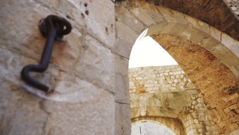 Dubrovnik,-atmospheric-street-and-walls-of-the-old-town-with-a-gate