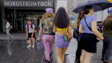 Nordstrom-closes-Canada-wide-despite-success-in-Vancouver-and-the-fashionable-center-of-Canada-in-Toronto-as-these-two-artistic-adults-walk-the-streets-of-downtown-at-Yonge-and-Bloor-on-rainy-day