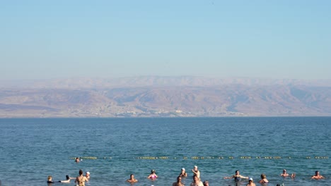 Group-of-people-floating-on-water-in-the-Dead-Sea-in-Israel