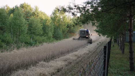 A-Perspective-of-a-combine-harvester-Cutting-Hay-in-the-Field-of-Borowy-Młyn,-Poland---Wide-Shot