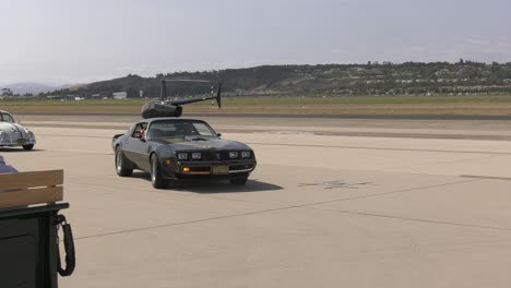 classic-cars-drive-through-airport