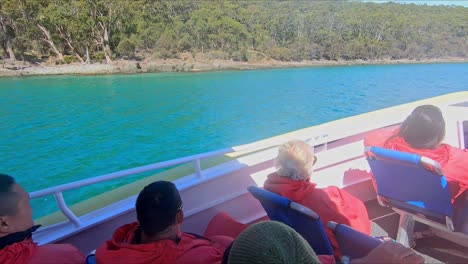 Bruny-Island,-Tasmania,-Australia---15-March-2019:-Passengers-on-a-tourist-boat-looking-at-the-view-along-the-shore-of-Bruny-Island-Tasmania