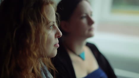 Brown-haired-multi-ethnic-young-girls-traveling-in-a-bus-to-Amsterdam,-closeup-shot