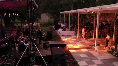 Zoom-in-drone-shot-of-a-orchestra-playing-at-a-wedding-party