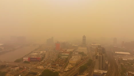 Western-wildfire-smoke-creates-fiery-skies-in-Concourse,-Bronx,-New-York-City---Aerial-view