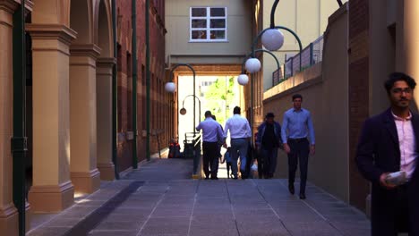 Office-workers-crossing-the-GPO-laneway-between-Queen-and-Elizabeth-street-during-lunch-time-rush-hours,-static-shot