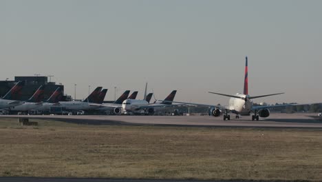 Wide-shot-of-ATL-airport-in-Atlanta,-Georgia-Delta-Terminal-as-as-single-commercial-airplane-taxis-into-its-gate