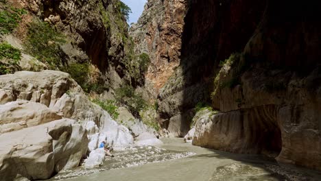 perspective-view-makes-person-tiny-in-narrow-ravine-river-gorge-environment