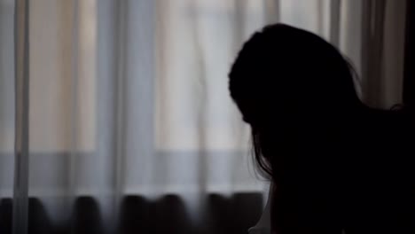 silhouette-shot-of-a-bride-standing-on-a-chair