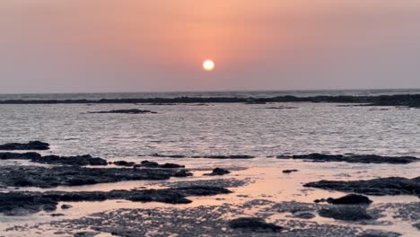 aerial-drone-camera-cinematic-shot-The-sun-is-setting-and-the-water-is-sparkling-with-the-rays-of-Sun