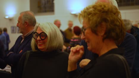 Couple-of-man-and-woman-wearing-trendy-designer-glasses-are-joking-during-social-event