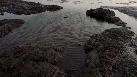 aerial-drone-camera-cinematic-shot-The-water-is-lapping-on-the-beach-and-the-water-is-sparkling-with-the-rays-of-sun