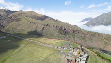 Gergeti-Holy-Trinity-church-Mount-Kazbegi-Caucasus-landscape-drone-orbital