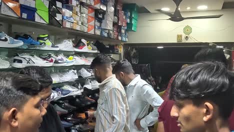 Toma-En-Primera-Persona,-Muchos-Chicos-Jóvenes-Comprando-En-Una-Tienda-De-Calzado-Deportivo.