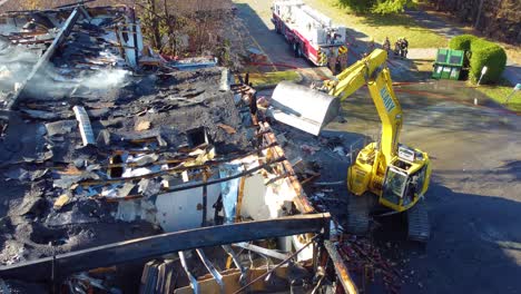 Excavator-Dismantling-Scorched-Architecture-After-Tragedy-Struck