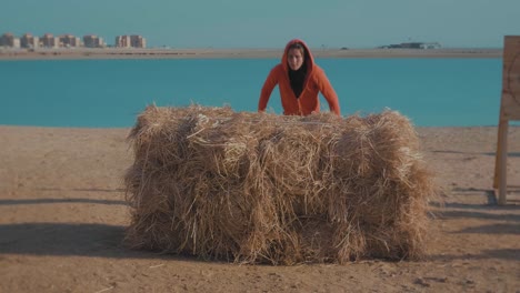 athletes-at-the-beach-doing-a-high-jump-on-rice-straw-Consecutively---Slow-Motion