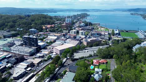 Drone-aerial-skyline-Gosford-city-CBD-waterfront-crane-construction-buildings-apartments-commercial-residential-architecture-Central-Coast-Australia-4K